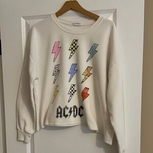 AC/DC Women's Cream Sweatshirt with Colorful Lightning Bolts.